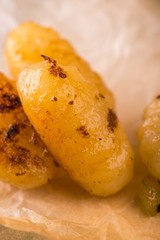 Detail of few pieces of gnocchi on paper sheet