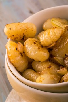 Portion Of Fried Gnocchi With Onion In Light Bowl