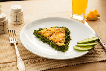 Healthy vegetarian breakfast with omelet made with vegetables and eggs fresh orange juice. Fast cooking lunch with organic ingredients.