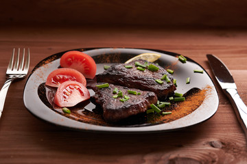 fried steak on a wooden table