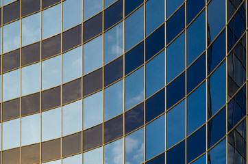 Curved glass facade of modern building. Abstract background