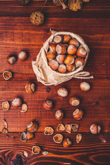 Still life with hazelnuts on a wooden background