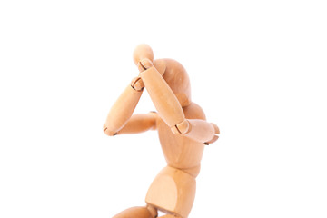 Depressed and sad wooden doll on a white background. Bad emotions concept.