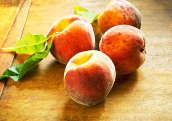 Fototapeta na wymiar Perfect ripe peaches on wooden table