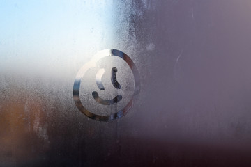 The inscription smile on the sweaty glass