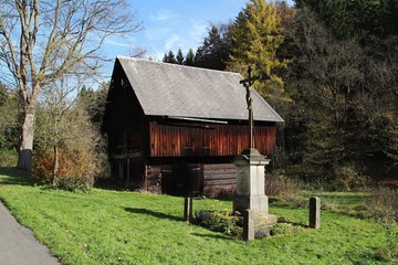 Old barn and cross in Bohemian Switzerland