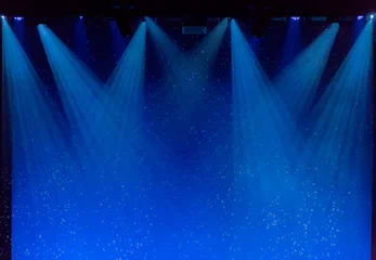 Papier Peint photo Lumière et ombre Bulles et rayons de lumière bleue à travers la fumée sur scène lors de représentations théâtrales.