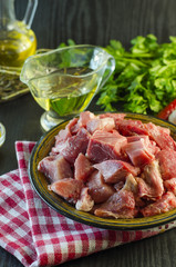 Raw meat chopped into pieces on a plate