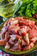 Raw meat chopped into pieces on a plate