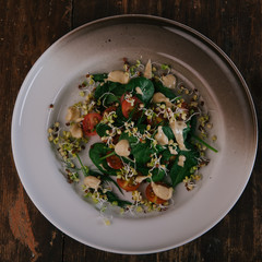 Healthy green salad with tomatoes, sprouts, spinach. Perfect for the detox diet or just a healthy meal.