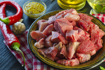 Raw meat chopped into pieces on a plate