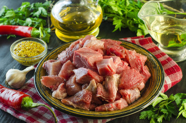 Raw meat chopped into pieces on a plate