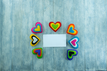 Multicolored hearts and blank card for wishes