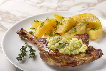 Roast duck with golden potatoes and garlic sauce with herbs