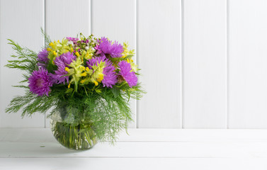 Fototapeta na wymiar Flowers bouquet in glass round vase