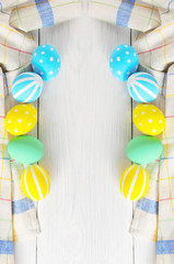 Frame with Easter eggs painted in pastel colors on a white background. Frame
