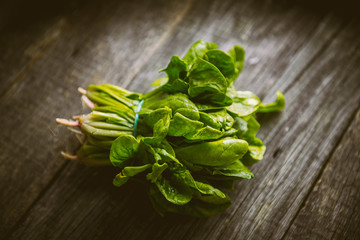 Fresh washed organic spinach on a cutting board