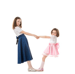 Two happy sisters in holiday dresses