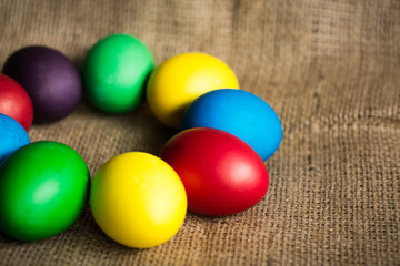 Obraz na płótnie Canvas Colored Easter eggs on a rustic background