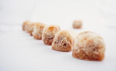 Arabian Eid dates sweets isolated. Oriental sweets with honey and nuts. Turkish Pakhlava Isolated On White. Turkish dessert.