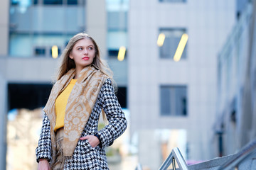 Blond hair young woman against modern building. Career and business opportunities concept. Street fashion style concept.