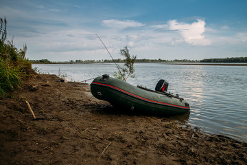 Inflatable fishing boat on the background of  river