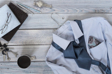 Fragment of a men's shirt with a tie on a hanger, diary, coffee 