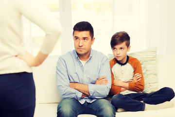 upset or displeased father, son and mother at home