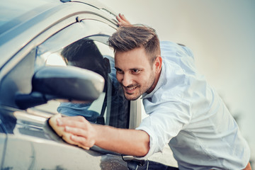 Man with a microfiber wipe the car polishing