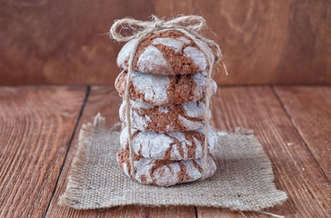 Homemade oat cookies with chocolate on a wooden background