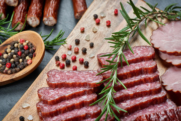 Set of cold cuts on a wooden board. Mix of sausages