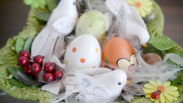 Easter eggs in a green basket with birdies.Easter decoration.Video rotation