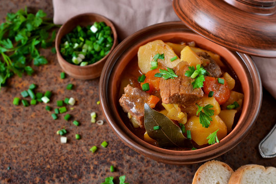 Stew with vegetables and potatoes on an old grunge background