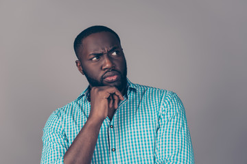 Portrait of distrusting afroamerican  bearded  man think and looking away