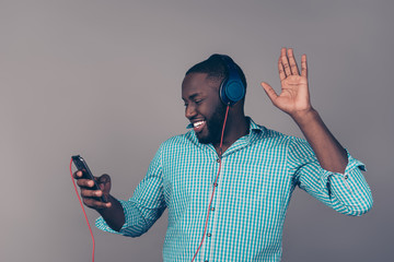 Portrait of happy afroamerican man listen to music on headphones and dance
