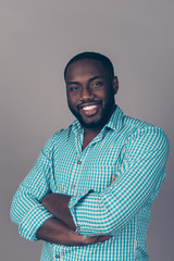 Portrait of successful serious  handsome afroamerican man in shirt crossed hands and smiling