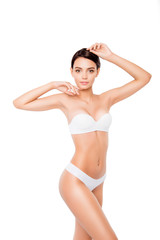 Fototapeta premium Full portrait of young pretty slim woman posing on isolated white background
