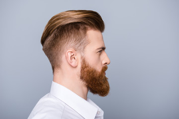 Side view portrait of confident bearded man with beautiful hairstyle   in white shirt looking on copy space