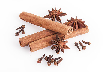 Cinnamon and anise on white background.