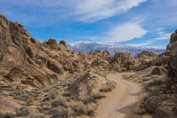 Road leading through the rock and boulders of southern California's Alabama Hills.