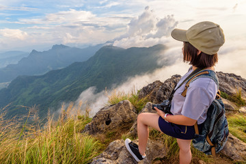 Hiker asian young woman happy with camera backpack and caps looking beautiful landscape nature of...