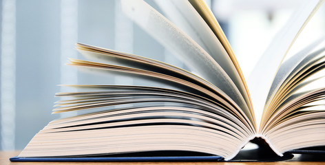 Hardcover book lying on the table in a library