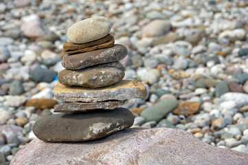 cairn of stacked stones on large boulder