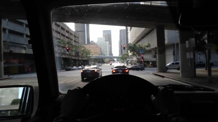 Driver POV coming to a red light and stopping