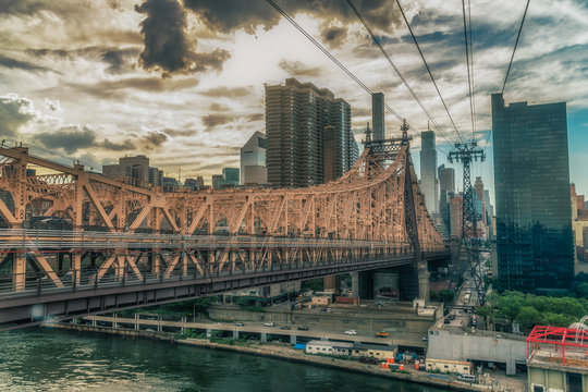 NEW YORK CITY, USA: The Queensboro Bridge is a two-level double cantilever bridge. It has two cantilever spans, one over the channel on each side of Roosevelt Island. Vivid image.