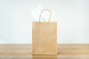 Mock-up of blank craft package, mockup of brown paper shopping bag with handles on the white background, front view