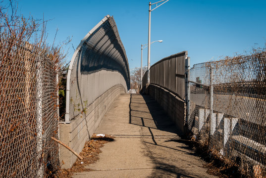 Fototapeta Urban chain link fence walkway. Industrial art and design. Overpass concrete bridge walkway.Black and white. Abstract art and design. Outdoor architectural detail and design. Abstract colors. 