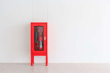 Fire Extinguisher in red Cabinet on Wall for fire protection in factory manufacturing with copy...