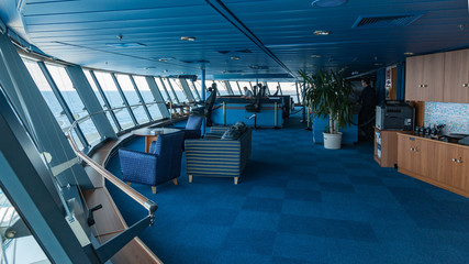 Obraz premium View from port wing looking towards helmsman position on bridge of large modern passenger cruise liner.
