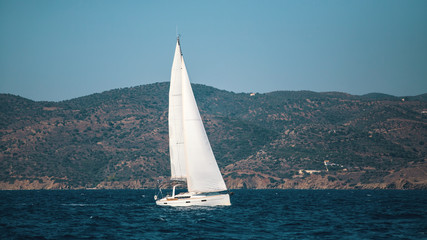 Fototapeta na wymiar Sailing ship yachts with white sails in the sea.